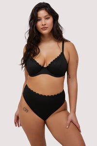 model wears black scalloped underwire bikini top and high waist brief swimwear set