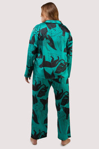 Green satin pyjamas with a pocket on the breast, in a black panther and leaf print design.