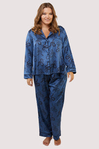 Blue satin pyjamas with a pocket on the breast, in a black snake print design.