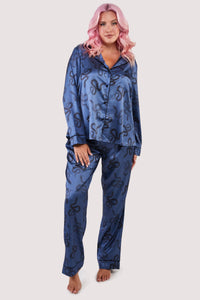 Blue satin pyjamas with a pocket on the breast, in a black snake print design.