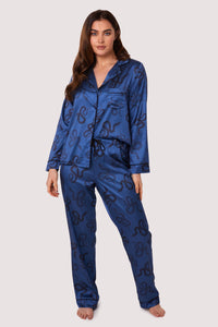 Blue satin pyjamas with a pocket on the breast, in a black snake print design.